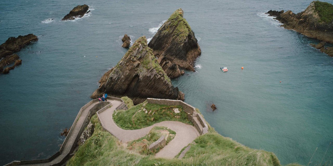 water surrounding grass and paths