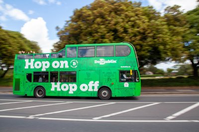 Tour bus in Phoenix Park, home of Dublin Zoo Passengers waving from open top tour bus